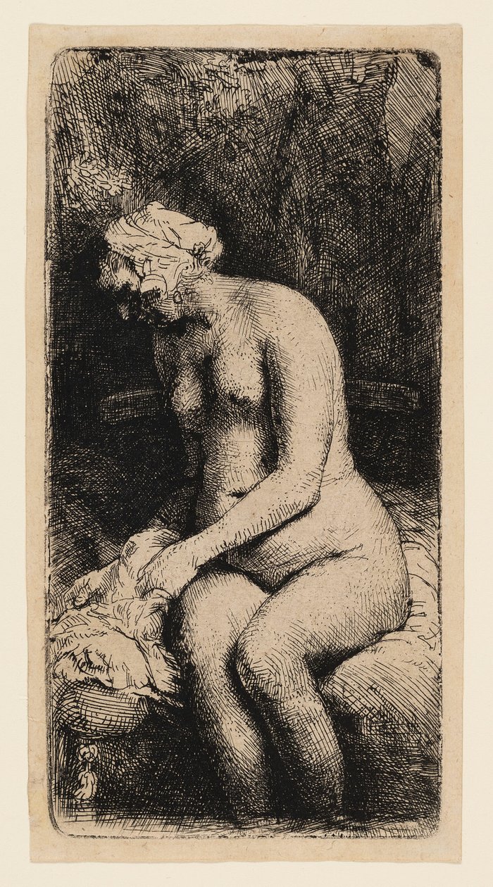 Kvinna som badar fötterna vid en bäck av Rembrandt van Rijn