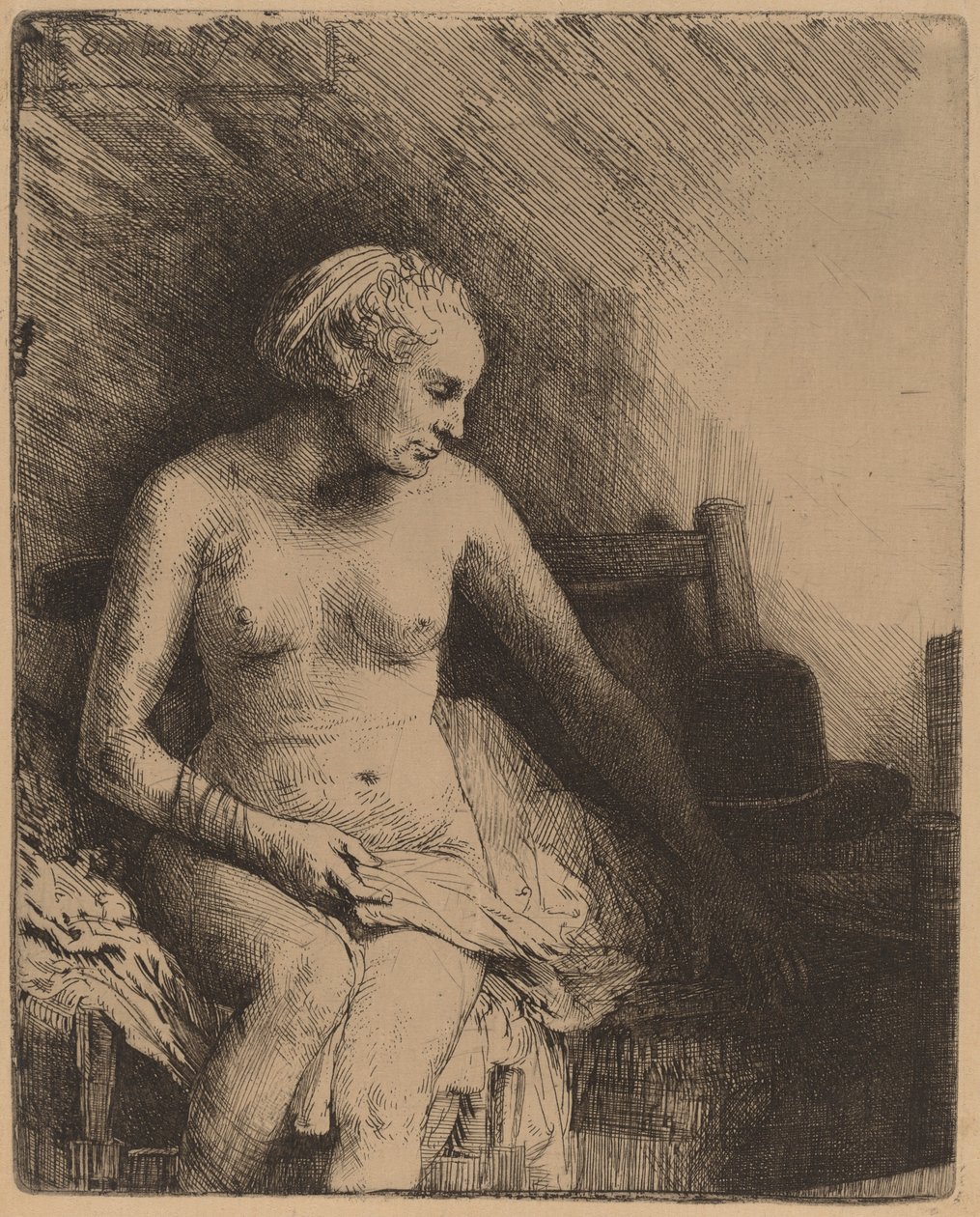 Kvinna vid badet med en hatt bredvid henne av Rembrandt van Rijn