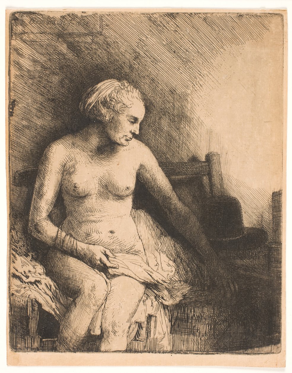 Kvinna vid badet, med en hatt bredvid sig av Rembrandt van Rijn