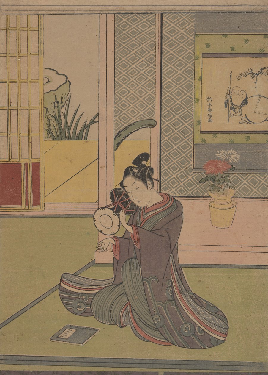 Ung man spelar en Noh-trumma. av Suzuki Harunobu