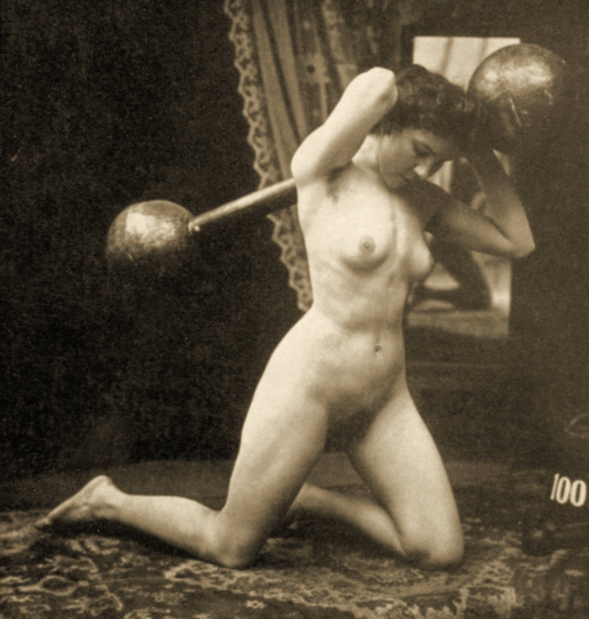 Naken kvinna tränar med en klotstång, ca 1900 (sepiafoto) av Unknown
