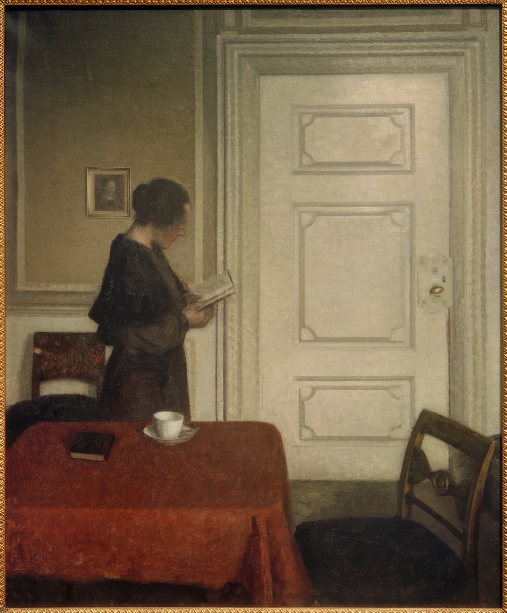 Läsande kvinna av Vilhelm Hammershoi