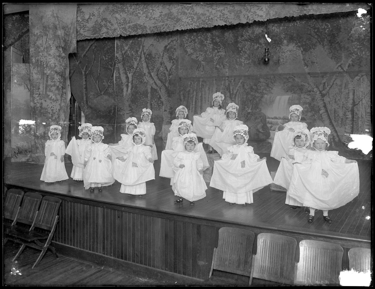 Dagisbarn på scenen: mycket små flickor uppträder på en liten scen, troligen den romersk-katolska föräldralöshetsanstalten, Kingsbridge, Bronx, ca 1911 av William Davis Hassler