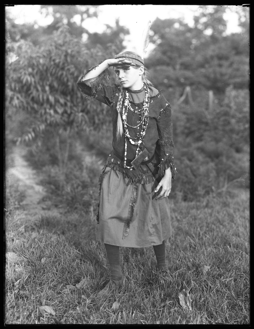 Oidentifierad flicka poserar i skogen i kostym, ca 1915 av William Davis Hassler