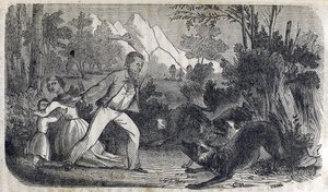 En man som står framför en kvinna och ett barn som slåss mot hundar av American School