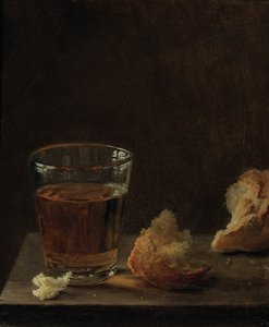 Ett glas öl och en fralla på ett bord