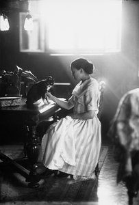 Porträtt av Wanda som sitter vid ett bord med sin katt, Trieste, ca 1910 (glasplatta)
