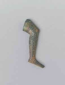 Litet blågrönt ogenomskinligt människoben av glas från en inläggsfigur (glas) av Egyptian