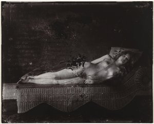 Naken kvinna på en schäslong Flicka på flätad schäslong, New Orleans (titel på objekt) av Ernest James Bellocq
