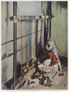 En kvinna som väver en gobeläng på en vävstol i Tunisien