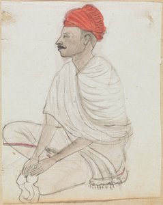 Man med en röd turban som sitter med korsbenen