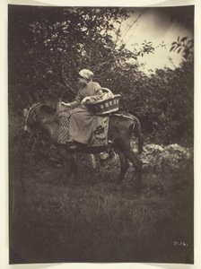 Kvinnlig bonde rider på åsna