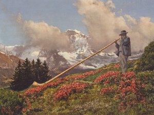 Schweiz: An Alphorn Blower, Jungfrau i bakgrunden (färgfoto)