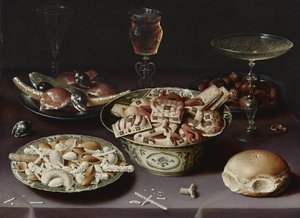 Stilleben med godis, kastanjer och en fralla