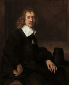 En ung man som sitter vid ett bord, möjligen Govaert Flinck, ca. 1660. av Rembrandt van Rijn
