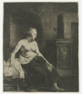Kvinna som sitter halvklädd bredvid en spis av Rembrandt van Rijn