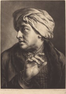 En man med turban och randig skjorta
