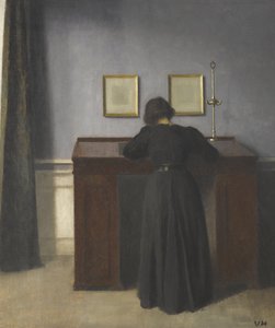 Ida står vid ett skrivbord av Vilhelm Hammershøi