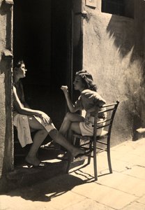 Två flickor sitter på en dörrtröskel. Vykort skickat av fotografen till Vincenzo Balocchi av Vincenzo Balocchi