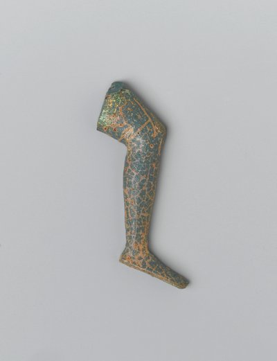 Litet blågrönt ogenomskinligt människoben av glas från en inläggsfigur (glas) av Egyptian