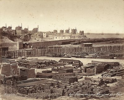 Gård för byggmaterial, väderkvarnar är i bakgrunden, i Alexandria, Egypten av Félix Bonfils