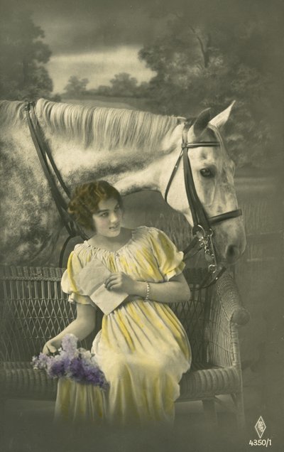 Flicka sitter på soffan med vit häst bakom (färgfoto) av French Photographer