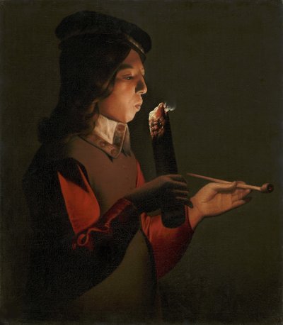 En ung pojke med en pipa, som blåser på en brandbrand, av La Tour, Georges, de (1583-1652). olja på duk av Georges de La Tour