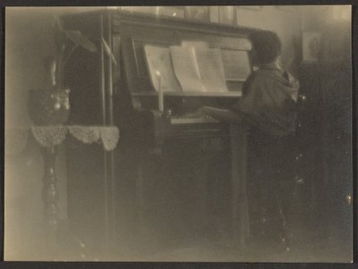 [Kvinna som spelar piano] av Louis Fleckenstein