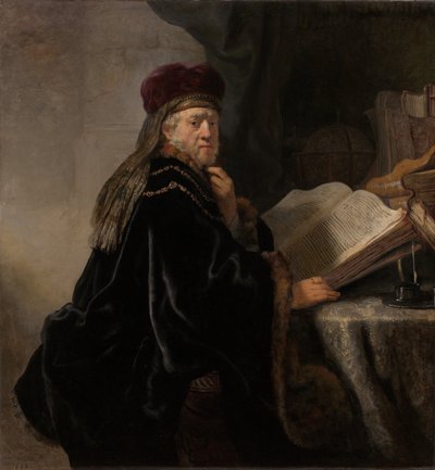 En forskare som sitter vid en skrivbordsforskare vid sin studie av Rembrandt van Rijn