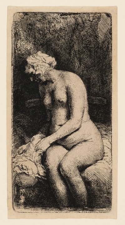 Kvinna som badar fötterna vid en bäck av Rembrandt van Rijn