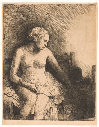 Kvinna vid badet, med en hatt bredvid sig av Rembrandt van Rijn