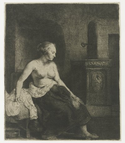 Kvinna som sitter halvklädd bredvid en spis av Rembrandt van Rijn