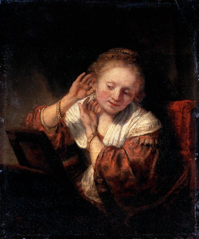 Ung kvinna prövar örhängen, 1657. av Rembrandt van Rijn