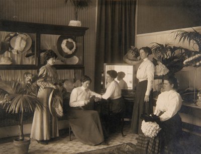 Fem damer i en modisteriaffär av Unidentified