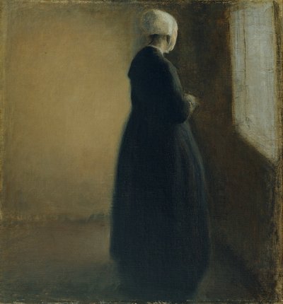 En gammal kvinna som står vid ett fönster av Vilhelm Hammershøi