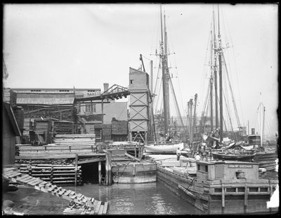 Bryggor och båtar vid oidentifierad vattenkant, möjligen Harlem River, Inwood, New York, ca 1910 av William Davis Hassler