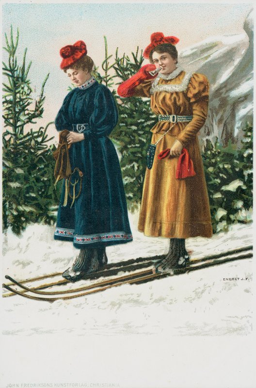 Två kvinnor på skidor när de åker nerför ett snöigt landskap av English School