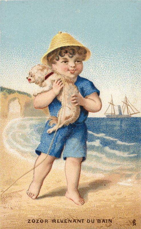 Pojke med hund på stranden av French School
