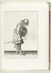 Övningen med sköld och spik: Soldaten placerar spiken på marken bredvid sin högra fot (nr 16), 1618 Nassausche Wapen-Handelinge, van Schilt, Spies, Rappier ende Targe: avbildad av figuren och poserad efter den nya ordningen [av] (...) M