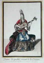 En dam som spelar gitarr