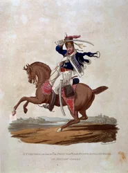 En korpral från 10:e eller Prince of Wales Own Royal Hussars i Review Order, från "Costumes of the Army of the British Empire, according to the last regulations 1812", graverad av J.C. Stadler, pub.