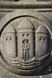 Symbol för tre torn huggen i en stenpelare på Rådhustorget