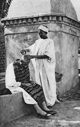 En gatubarberare och hans klient, Algeriet, Afrika, 1922.