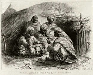 En köpman som fascinerar en kund, sittande på golvet, på en liten matta, han gör artikeln genom att hålla i en våg. Gravyr av Riou, för att illustrera historien ""Från Niger till Guineebukten", av kapten Louis Gustave Binger (1856-1936), 1887-1889, i