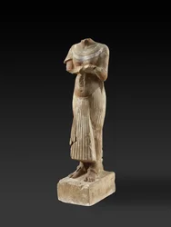 Figur av farao Akhenaton som håller ett offerbord (huggen och målad sandsten)