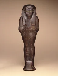 Shawabti av Maya, New Kingdom, c.1390-1353 f.Kr. (trä, färg och glas)