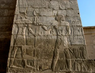 Egyptisk antiken: Ramses III:s begravningstempel (1187-1156 f.Kr.). Låg relief som representerar faraon som tar emot maktens insignier från Amuns händer. Luxor, Medinet Habou, Egypten