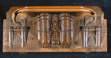 En misericord som föreställer Sir Yvains häst instängd när porten till en utstuderad slottsingång sänks, New College Chapel, Oxford, sent 1300-tal (trä)