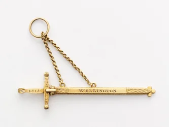 Miniatyr jubileumssvärd (trä och guld)