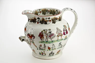 Staffordshire-kanna dekorerad med Harlequin-figurer och karnevalstema, 1866 (järnstenskina)